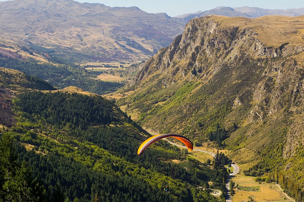 A paraglider over a valley near Queenstown